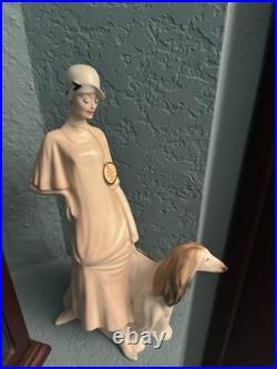 Royal Doulton Figure Women walking her dog. I believe made of Porcelain. Tall